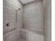 Updated tile shower with a built-in bench and hand-held shower head at 8562 Acorn Ridge Ct, Tampa, FL 33625