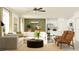 A cozy open-concept living room and kitchen with modern furniture, neutral colors, and natural light at 8625 Linked Dr, New Port Richey, FL 34655