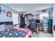 Cozy bedroom with light gray plank flooring, ceiling fan, and an eclectic mix of decorative accents at 902 W Columbus Dr, Tampa, FL 33602