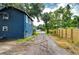 Long driveway leading to the home, lined with lush greenery and a wooden privacy fence at 902 W Columbus Dr, Tampa, FL 33602