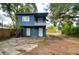 Charming home featuring a classic blue exterior with a small balcony and spacious parking area at 902 W Columbus Dr, Tampa, FL 33602
