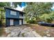 Charming home featuring a classic blue exterior with a small balcony and spacious parking area at 902 W Columbus Dr, Tampa, FL 33602
