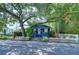 Charming home featuring mature trees, a welcoming porch and a classic white picket fence at 902 W Columbus Dr, Tampa, FL 33602