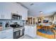 Updated kitchen with stainless steel appliances and granite countertops opening to dining area at 902 W Columbus Dr, Tampa, FL 33602