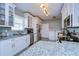 Updated kitchen with white cabinets, granite countertops, and a convenient laundry area at 902 W Columbus Dr, Tampa, FL 33602
