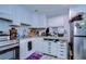 Bright kitchen featuring white cabinets, granite countertops, and stainless steel appliances at 902 W Columbus Dr, Tampa, FL 33602