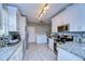 Well-lit kitchen area with granite countertops, white cabinets, and stainless steel appliances at 902 W Columbus Dr, Tampa, FL 33602