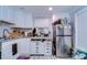 Bright kitchen featuring white cabinets, granite countertops, and stainless steel appliances at 902 W Columbus Dr, Tampa, FL 33602