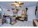 Unique living room with light gray plank flooring, ceiling fan, and an eclectic mix of decorative accents at 902 W Columbus Dr, Tampa, FL 33602