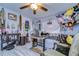 Unique living room with light gray plank flooring, ceiling fan, and an eclectic mix of decorative accents at 902 W Columbus Dr, Tampa, FL 33602