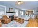 Comfortable living room with fireplace, hardwood floors, and an open floorplan to the kitchen at 902 W Columbus Dr, Tampa, FL 33602