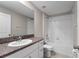 Well lit bathroom with a combination tub and shower unit, granite countertop and white cabinets at 937 Royal Empress Dr, Ruskin, FL 33570