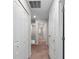 Upstairs hallway with plush carpeting, featuring storage and access to multiple rooms at 937 Royal Empress Dr, Ruskin, FL 33570
