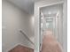 Upstairs hallway featuring neutral walls, plush carpeting, and abundant natural light at 937 Royal Empress Dr, Ruskin, FL 33570