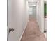 Charming hallway with carpeting leading to bedrooms, kitchen view, and ample natural light at 937 Royal Empress Dr, Ruskin, FL 33570