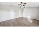 Bedroom features hardwood floors, ceiling fan, and neutral paint at 9479 Southern Charm Cir, Brooksville, FL 34613