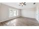 Bedroom features hardwood floors, large windows, and neutral paint at 9479 Southern Charm Cir, Brooksville, FL 34613
