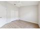 Large bedroom with closet, ceiling fan, and neutral paint, and wood-look laminate flooring throughout at 9479 Southern Charm Cir, Brooksville, FL 34613