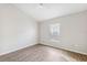 Bright bedroom featuring hard surface flooring, ceiling fan, and window bringing in natural light at 9479 Southern Charm Cir, Brooksville, FL 34613