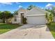Neat single-story home boasts a well-kept lawn and features a convenient attached two-car garage at 9479 Southern Charm Cir, Brooksville, FL 34613