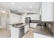 Bright kitchen features white cabinets, stainless steel appliances, and center island at 9479 Southern Charm Cir, Brooksville, FL 34613
