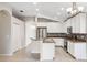 Bright kitchen features white cabinets, stainless steel appliances, and center island at 9479 Southern Charm Cir, Brooksville, FL 34613