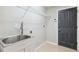 Laundry room with utility sink and door at 9479 Southern Charm Cir, Brooksville, FL 34613