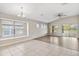 Open living room with hardwood floors, lots of light, and vaulted ceilings at 9479 Southern Charm Cir, Brooksville, FL 34613