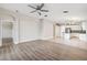 Open living room features hardwood floors and connects to the kitchen at 9479 Southern Charm Cir, Brooksville, FL 34613