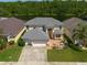 An aerial view of the home, which features a well-manicured lawn and stone planters at 10522 Sky Flower Ct, Land O Lakes, FL 34638