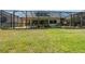 Spacious backyard featuring a screened pool and grassy area, perfect for recreation and outdoor activities at 10522 Sky Flower Ct, Land O Lakes, FL 34638