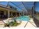 Relax and unwind in this screened pool and lanai area, perfect for outdoor dining and entertaining at 10522 Sky Flower Ct, Land O Lakes, FL 34638