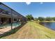 Large backyard with screened in pool overlooking waterfront view at 10522 Sky Flower Ct, Land O Lakes, FL 34638