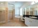 Luxurious bathroom with a soaking tub, a walk-in shower, and granite countertops at 10522 Sky Flower Ct, Land O Lakes, FL 34638