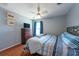 Cozy bedroom offers a ceiling fan, hardwood floors and natural light from the window at 10522 Sky Flower Ct, Land O Lakes, FL 34638