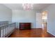Bedroom features a gray crib, dresser, hardwood floors, and a whimsical chandelier, creating a cozy and inviting space at 10522 Sky Flower Ct, Land O Lakes, FL 34638