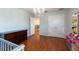 Bedroom with hardwood floors, dresser, built-in storage, and access to additional rooms provides versatile living space at 10522 Sky Flower Ct, Land O Lakes, FL 34638