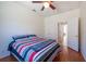 This bedroom features a ceiling fan, wood floors, and is conveniently located near a full bathroom at 10522 Sky Flower Ct, Land O Lakes, FL 34638