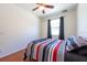 Comfortable bedroom with a ceiling fan, warm wood floors, and natural light at 10522 Sky Flower Ct, Land O Lakes, FL 34638