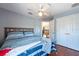 Bedroom with ceiling fan, wood floor and closet with doors leading to landing at 10522 Sky Flower Ct, Land O Lakes, FL 34638