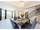 Elegant dining room featuring a modern chandelier and large windows at 10522 Sky Flower Ct, Land O Lakes, FL 34638
