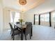 Elegant dining room featuring a modern chandelier and large windows at 10522 Sky Flower Ct, Land O Lakes, FL 34638