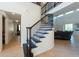 Elegant foyer showcases a curved staircase with decorative iron spindles and tile flooring leading to the living area at 10522 Sky Flower Ct, Land O Lakes, FL 34638