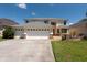 Charming two-story home with a three-car garage and well-manicured lawn, exuding curb appeal at 10522 Sky Flower Ct, Land O Lakes, FL 34638