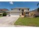 Charming two-story home with manicured lawn and a three car garage at 10522 Sky Flower Ct, Land O Lakes, FL 34638