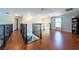 Second floor hallway features hardwood floors, decorative iron railings, and ample space for flexible use at 10522 Sky Flower Ct, Land O Lakes, FL 34638