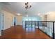 Spacious second-floor hallway boasts hardwood floors, recessed lighting, and decorative wrought iron railing at 10522 Sky Flower Ct, Land O Lakes, FL 34638