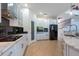 Bright kitchen with white cabinets, black backsplash, tiled island, and stainless steel appliances at 10522 Sky Flower Ct, Land O Lakes, FL 34638