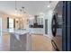 Bright kitchen with white cabinets, black backsplash, tiled island, and stainless steel appliances at 10522 Sky Flower Ct, Land O Lakes, FL 34638