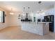 Bright kitchen with white cabinets, black backsplash, tiled island, and stainless steel appliances at 10522 Sky Flower Ct, Land O Lakes, FL 34638
